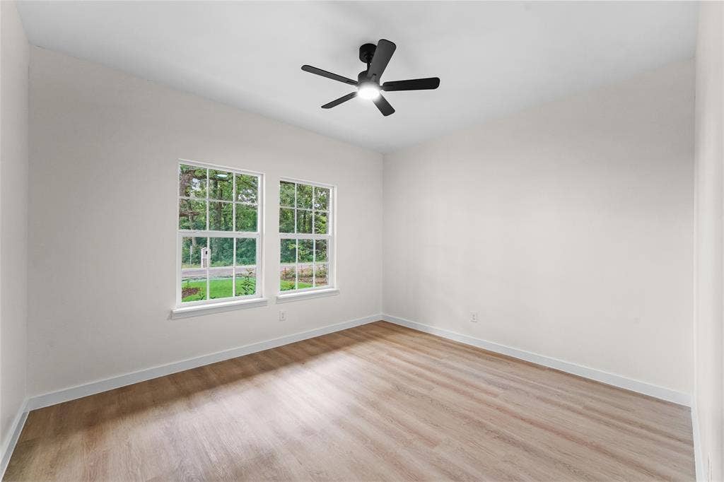 231 E Beachwood Loop, Trinidad, TX 75163 Bright interior featuring wood-finish flooring, white walls, and a modern ceiling fan
