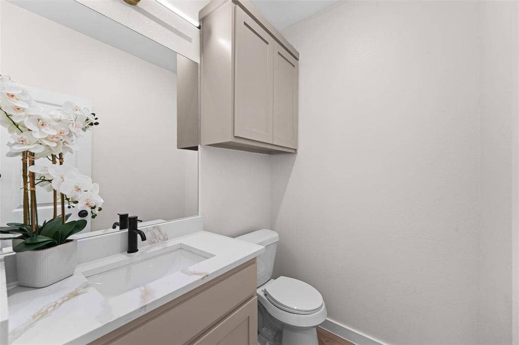 231 E Beachwood Loop, Trinidad, TX 75163 Contemporary bathroom vanity featuring a rectangular undermount sink, a quartz countertop with subtle veining, and a matte black single-handle faucet