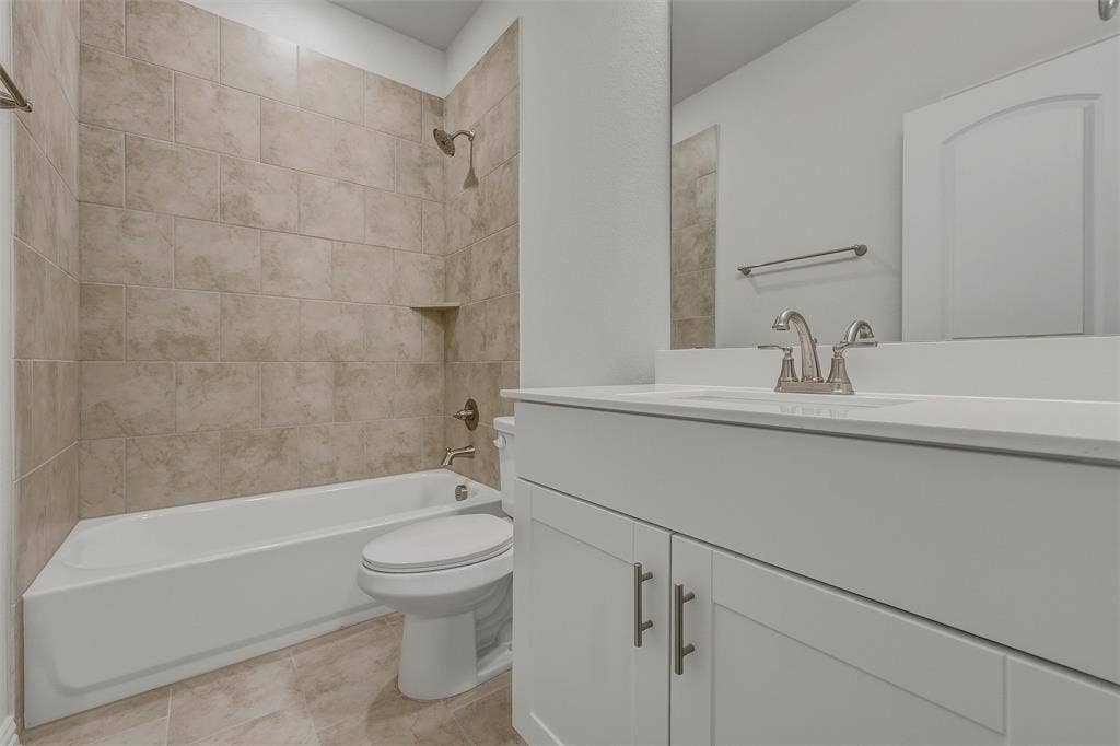 White vanity with brushed nickel hardware and integrated sink