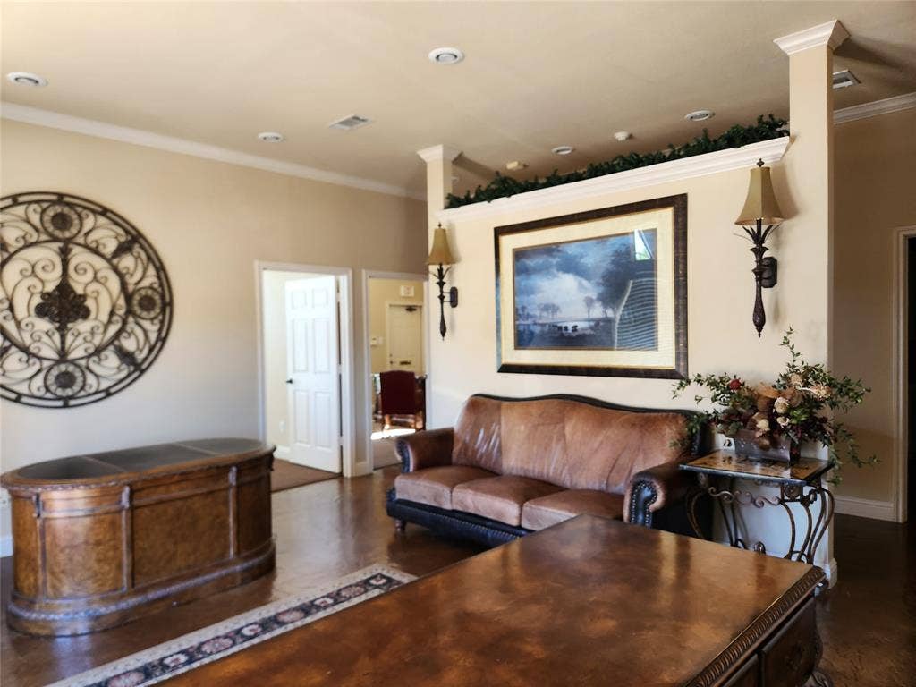 1905 W Ennis Avenue, #301, Ennis, TX 75119 Recessed lighting illuminates a spacious room featuring crown molding and wood-finish flooring
