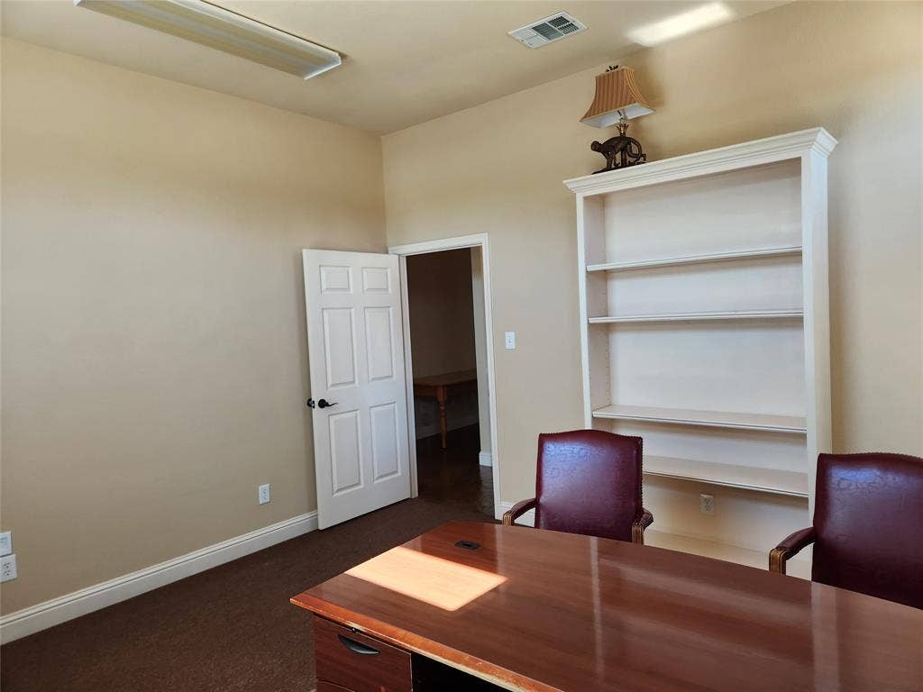1905 W Ennis Avenue, #301, Ennis, TX 75119 Built-in shelving unit with crown molding, presenting display and storage capabilities