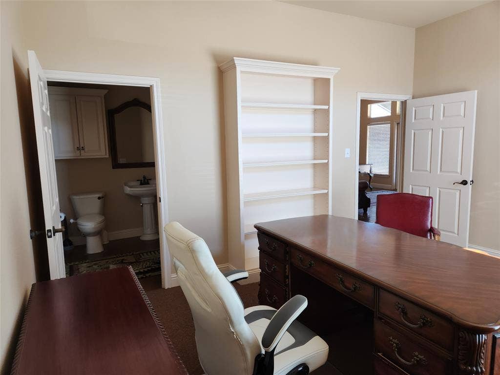 1905 W Ennis Avenue, #301, Ennis, TX 75119 Room featuring neutral wall tones, built-in shelving, and carpet flooring
