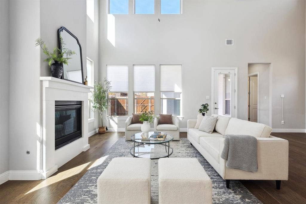Living area featuring soaring ceilings and high windows