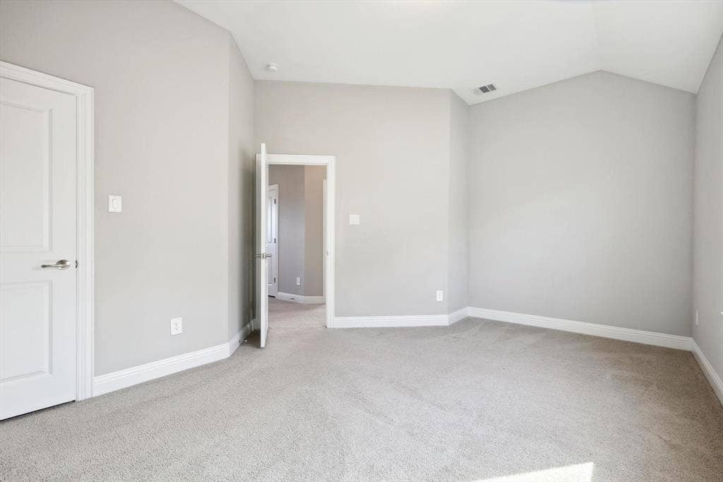 Neutral gray wall paint, light gray carpeting, white baseboards, and white interior doors