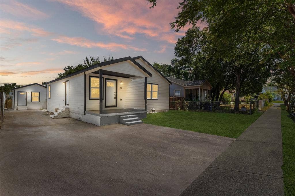 106 Mount Shasta Street, Dallas, TX 75211 Contemporary exterior with white siding, black trim, and a covered front porch