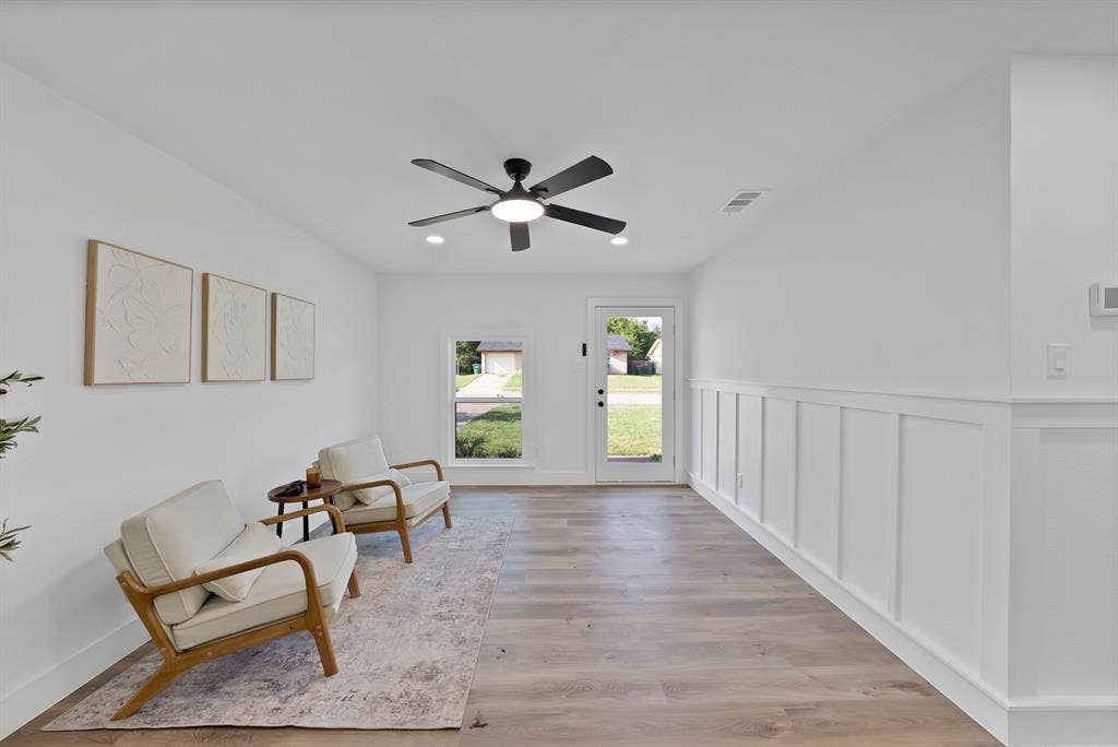 132 Yorkshire Drive, Cedar Hill, TX 75104 Spacious room featuring wood-finish flooring, crisp white walls, and a contemporary ceiling fan