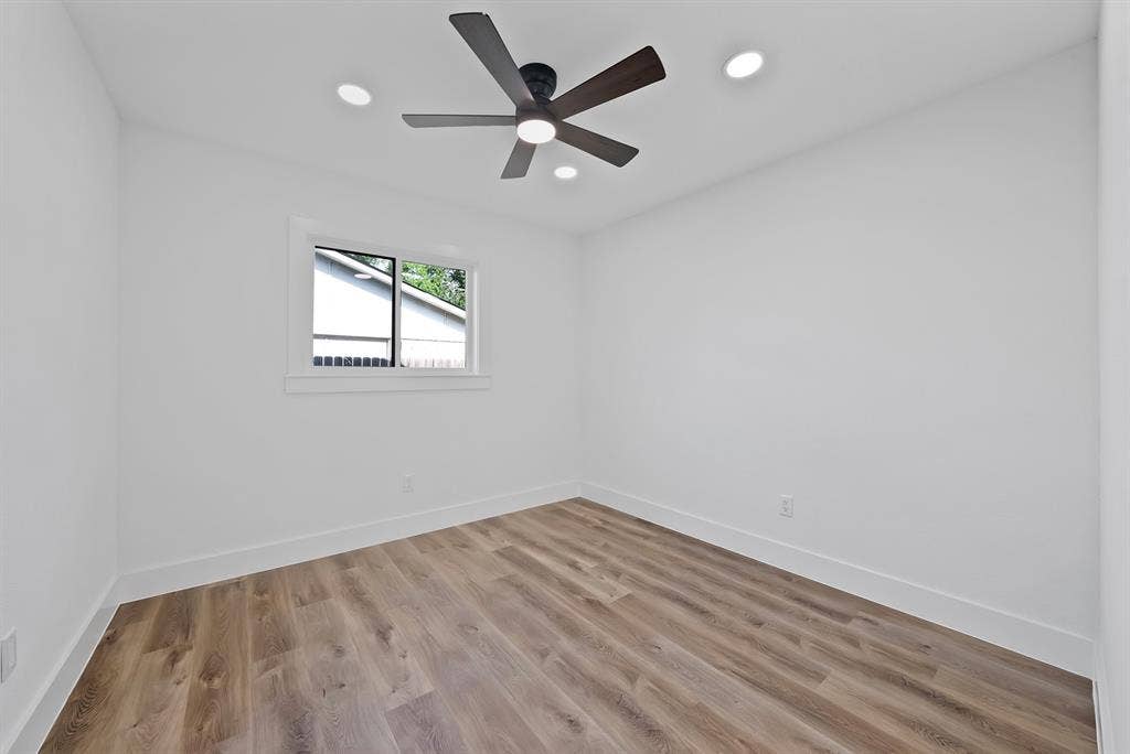 132 Yorkshire Drive, Cedar Hill, TX 75104 Spacious room featuring wood-finish flooring, white walls, and a modern ceiling fan with integrated lighting