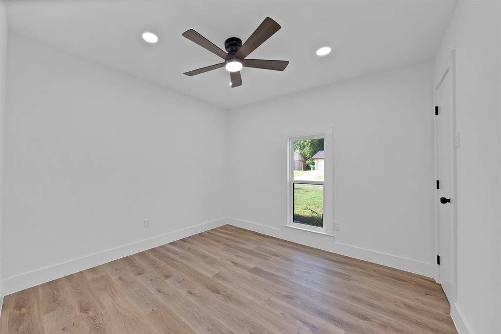 132 Yorkshire Drive, Cedar Hill, TX 75104 Room featuring wood-finish flooring, white baseboards, and a contemporary ceiling fan with integrated lighting