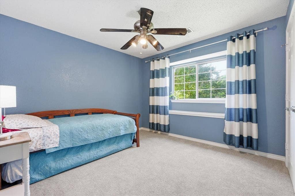 510 Saralvo Road, Midlothian, TX 76065 Room featuring light blue walls, soft grey carpeting, a multi-pane window, and a ceiling fan with integrated lighting