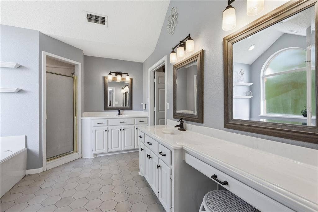 510 Saralvo Road, Midlothian, TX 76065 Dual vanity with white cabinetry, solid surface countertops, and framed mirrors