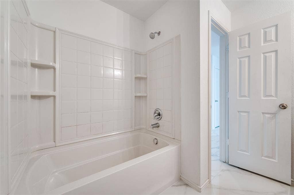 12841 Serenity Drive, Frisco, TX 75035 White tub and shower combination with integrated shelving