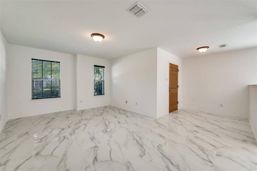 12841 Serenity Drive, Frisco, TX 75035 Spacious room featuring white walls and marble-look tile flooring