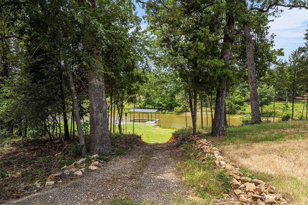 14120 Park Way, Log Cabin, TX 75148 Home sits up on a bluff. Golf cart path to flat grassy acreage and boat dock