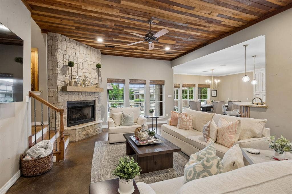 1700 Rock Ridge Road, Lucas, TX 75002 The wood ceiling and stacked stone fireplace give the family room a cozy, rustic charm.