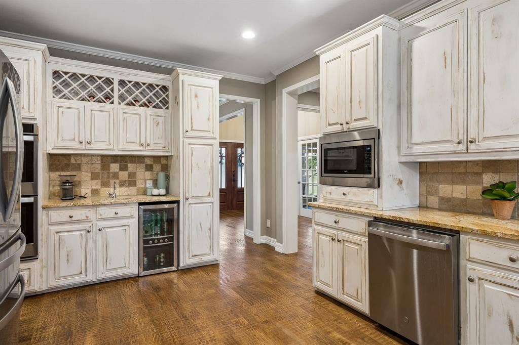 1700 Rock Ridge Road, Lucas, TX 75002 The kitchen is already spacious and functional, with stainless appliances, refrigerator and beverage frig, and coffee bar.