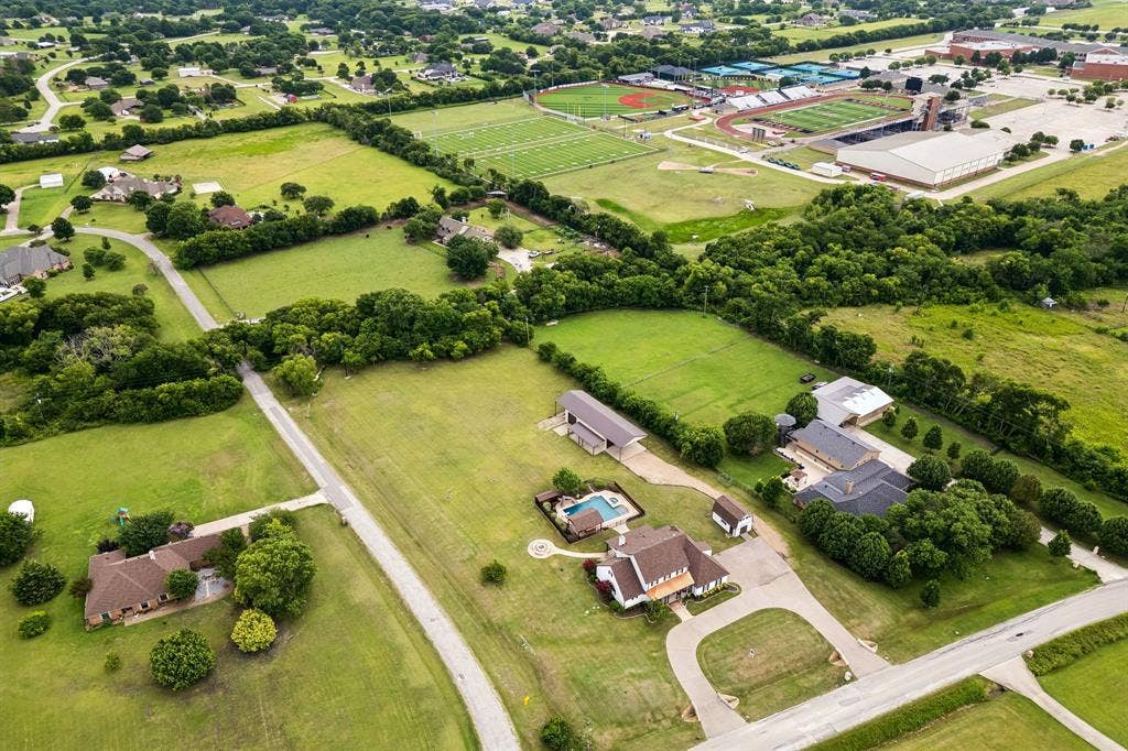 1700 Rock Ridge Road, Lucas, TX 75002 With Lovejoy High School in the background, enjoy one of the best locations. All homes in the neighborhood sit on a minimum of 2 acres, so there's lots of elbow room. Don't miss the treehouse in the wooded area at the back of the property.