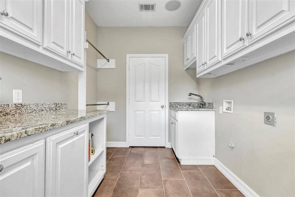 1700 Rock Ridge Road, Lucas, TX 75002 Love this laundry room with all the extra cabinetry, countertop, and sink.