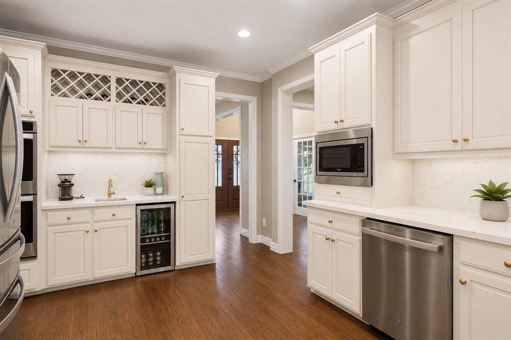 1700 Rock Ridge Road, Lucas, TX 75002 Update to kitchen includes painting cabinets, adding quartz to counters and backsplash, new hardware and sink.