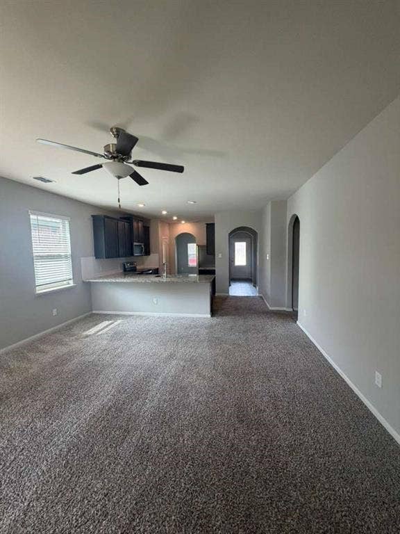 310 Foster Lane, Anna, TX 75409 Open-concept living area featuring a ceiling fan, plush carpet, and a kitchen with dark cabinetry, light countertops, and recessed lighting