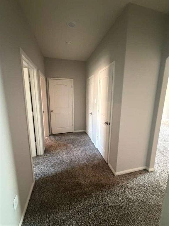 310 Foster Lane, Anna, TX 75409 Hallway with light gray walls, dark gray carpeting, recessed ceiling lighting, and multiple white panel doors