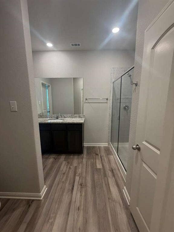 310 Foster Lane, Anna, TX 75409 Bathroom featuring wood-finish flooring and a dark wood vanity with a light-colored countertop