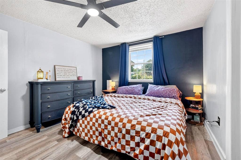 810 Edna Street, Athens, TX 75751 Bedroom featuring wood-finish flooring, a ceiling fan with integrated lighting, and a window with natural light