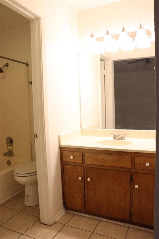 10020 Redondo Drive, Dallas, TX 75218 Bathroom vanity with wood-finish cabinetry, a light-toned countertop, and an integrated sink