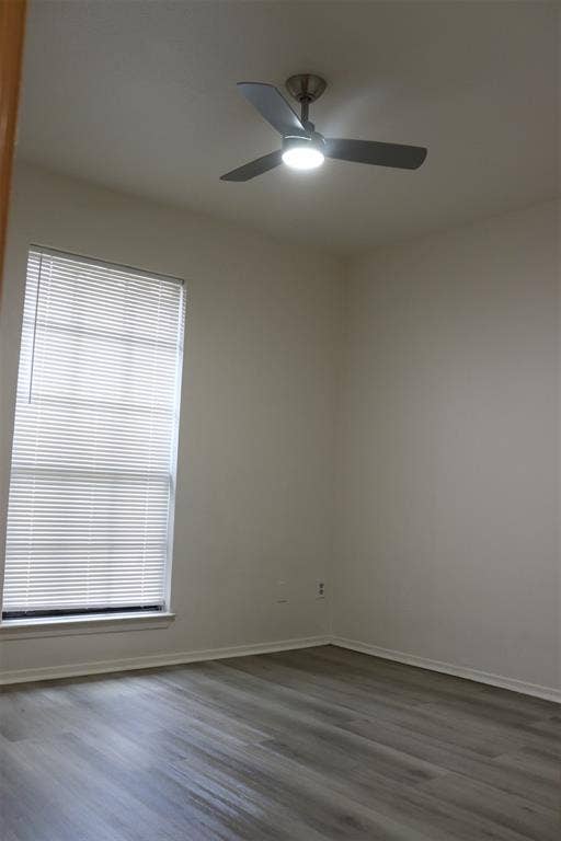 10020 Redondo Drive, Dallas, TX 75218 Interior room featuring light gray wood-finish flooring, a window with horizontal blinds, and a ceiling fan with integrated lighting