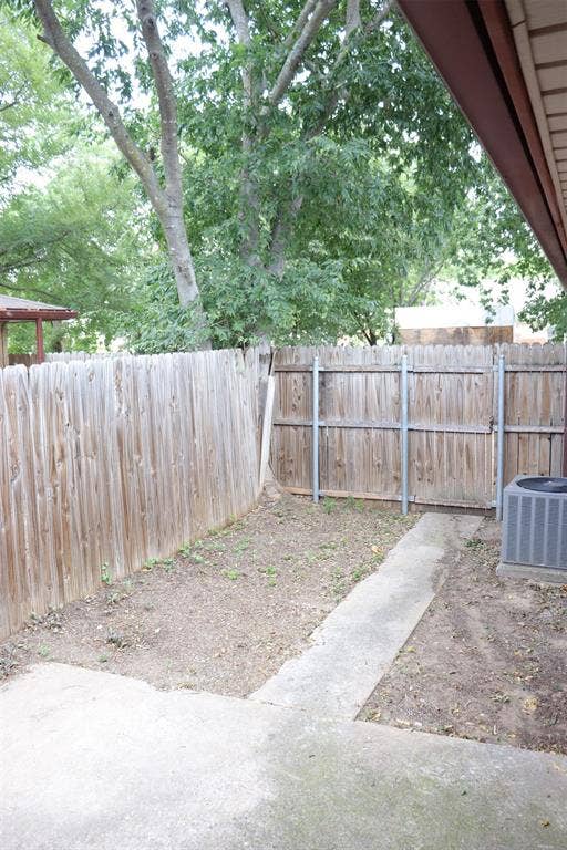 10020 Redondo Drive, Dallas, TX 75218 Private outdoor space featuring a wood fence, concrete patio, and garden area
