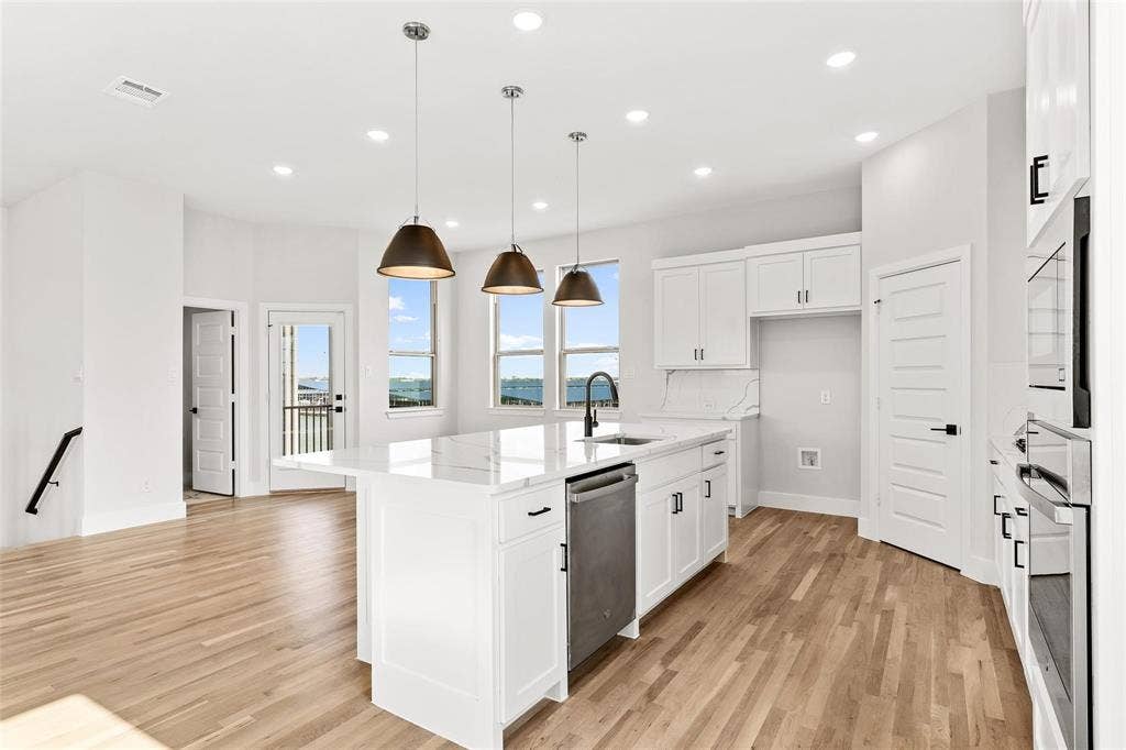 1101 Marc Lane, Rowlett, TX 75088 Oversized kitchen island with pendant lighting open to living area perfect for entertaining. Stainless appliances with gas cooktop