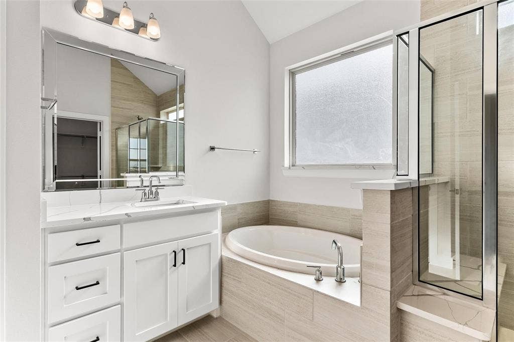 1101 Marc Lane, Rowlett, TX 75088 Primary bathroom with dual vanities, separate tub and walk in shower.