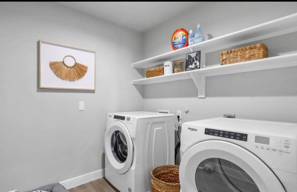 300 Libby Lane, Mansfield, TX 76063 Dedicated laundry area featuring a front-loading washer and dryer, light gray walls, and wood-finish flooring