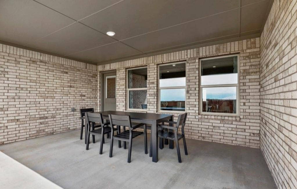 300 Libby Lane, Mansfield, TX 76063 Covered patio featuring a concrete slab, brick exterior walls, and a recessed ceiling light