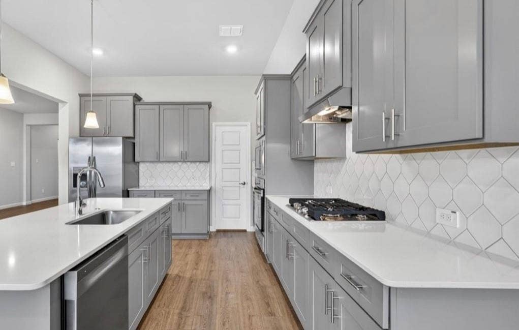 300 Libby Lane, Mansfield, TX 76063 Kitchen featuring light gray cabinetry, stainless steel appliances, a gas range, white countertops, and a white geometric tile backsplash