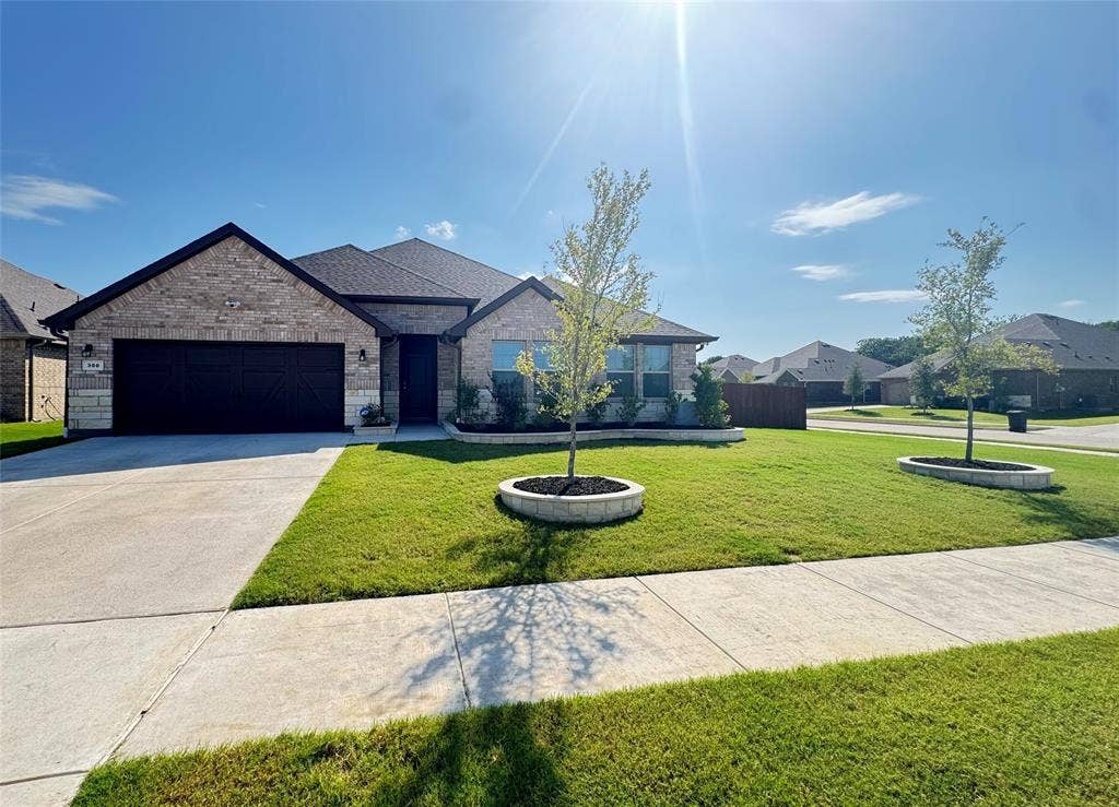 300 Libby Lane, Mansfield, TX 76063 Single-story residence featuring a brick and stone exterior, a two-car garage, and a dark shingled roof