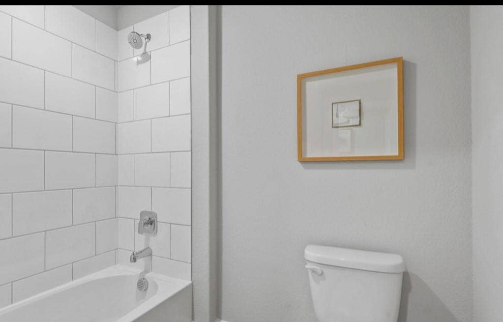 300 Libby Lane, Mansfield, TX 76063 Bathtub with a shower, white subway tile surround, and chrome fixtures