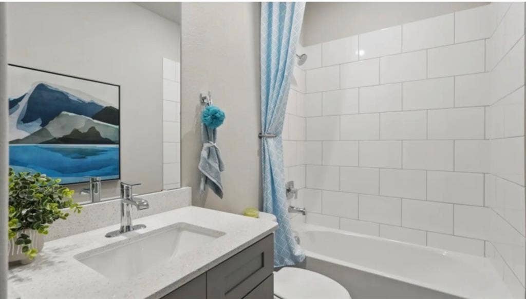 300 Libby Lane, Mansfield, TX 76063 Bathroom featuring a vanity with an integrated sink, polished chrome faucet, and grey cabinetry