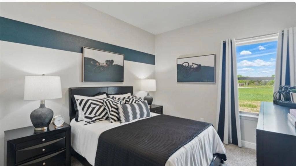 300 Libby Lane, Mansfield, TX 76063 Bedroom featuring a large window, patterned accent wall, dark wood-finish furniture, and light-toned carpet flooring