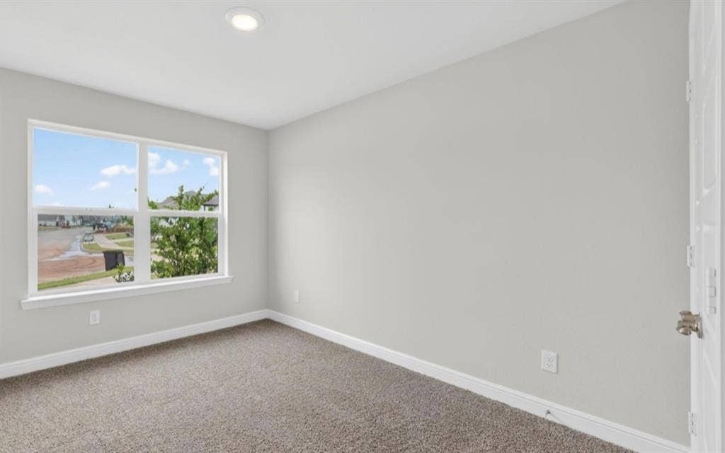 300 Libby Lane, Mansfield, TX 76063 Bright room featuring a large multi-pane window, recessed ceiling lighting, light gray wall paint, white trim, and neutral-toned carpet