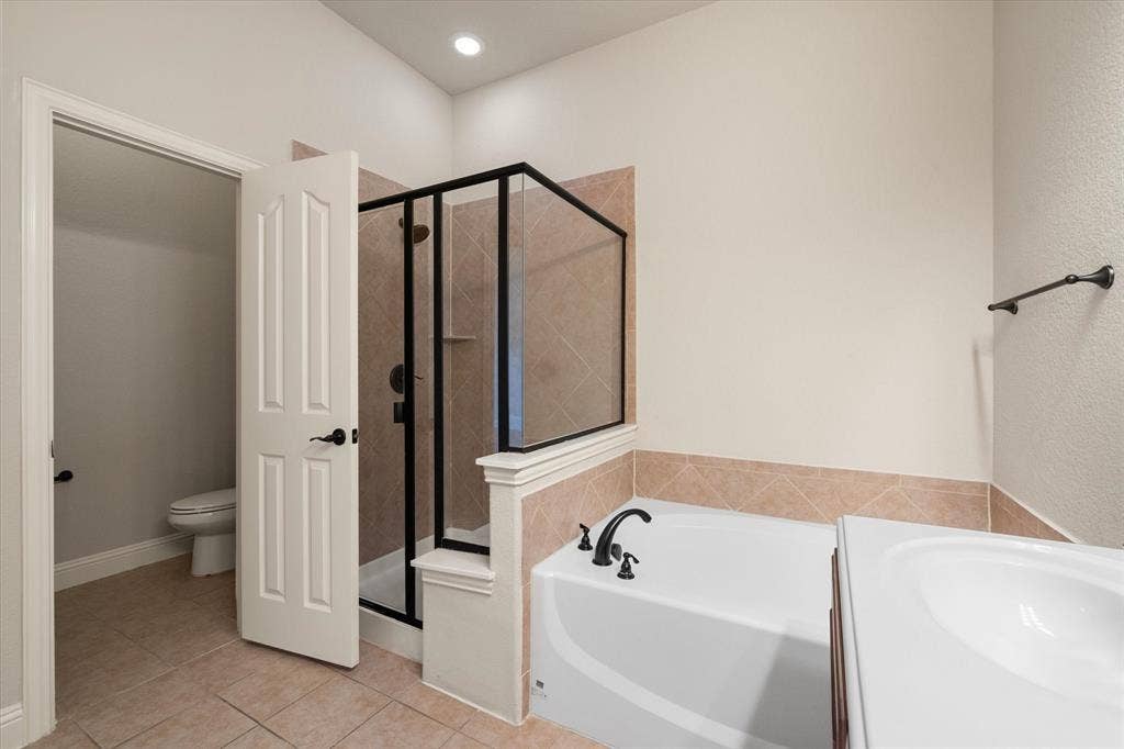 Bathroom featuring a built-in tub & separate shower