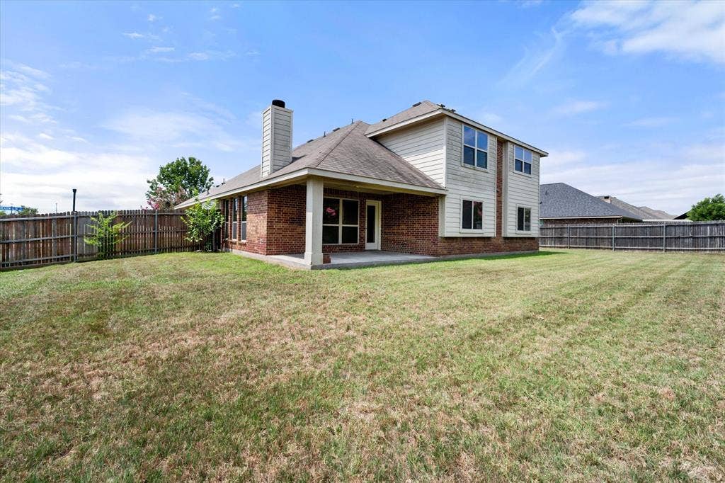 Spacious backyard featuring a covered patio