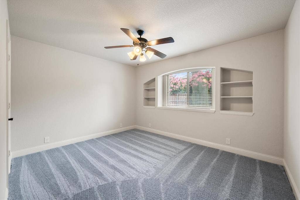 Bedroom with built in shelving