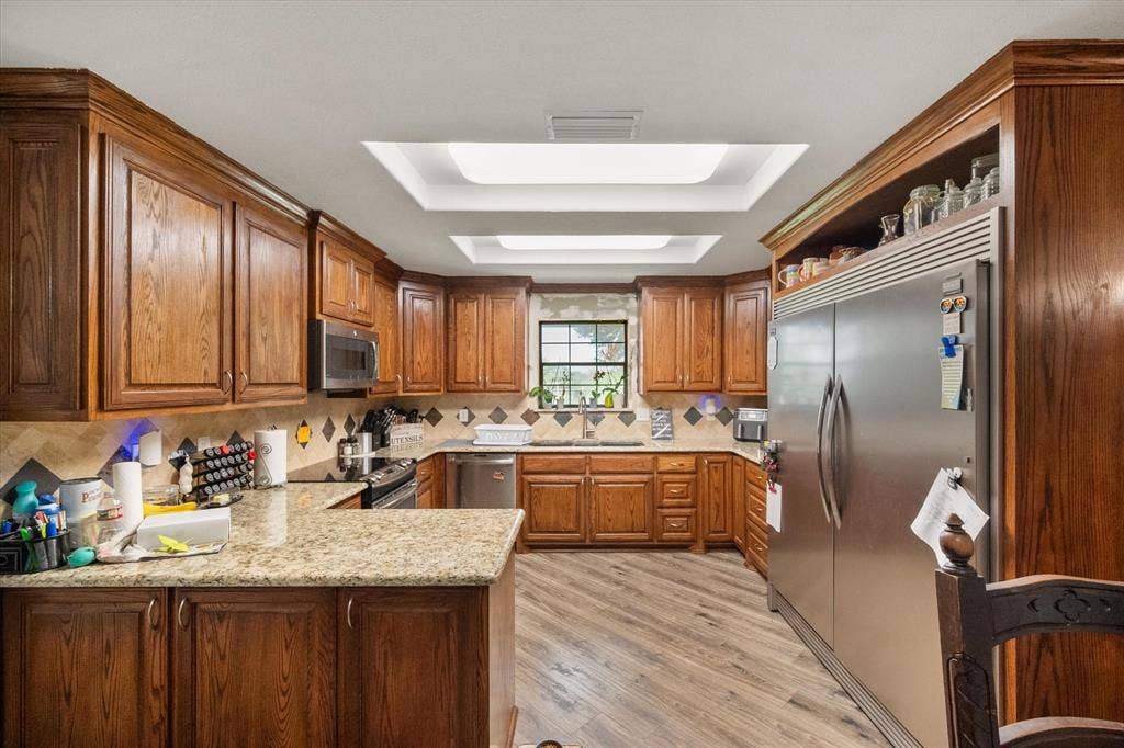 THIS KITCHEN IS A SHOW STOPPER! Gorgeous cabinetry, granite counters, stainless appliances. The built-in fridge is actually a full refrigerator on the right and a full freezer on the left.