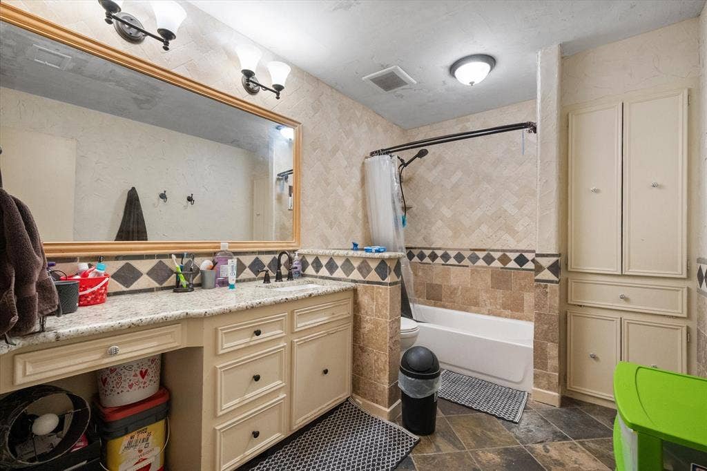 Nearly complete, beautifully updated Hall bath with lots of storage and granite counter.