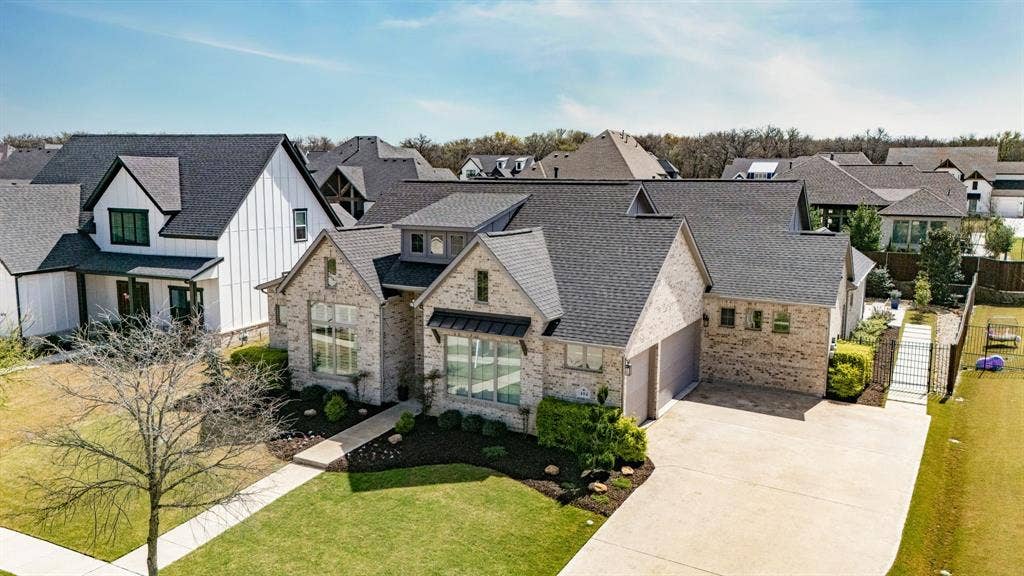 404 Travelers Terrace, Argyle, TX 76226 3 car garage plus extra parking. Roof replaced in 2025 & has a continuous ridge vent.