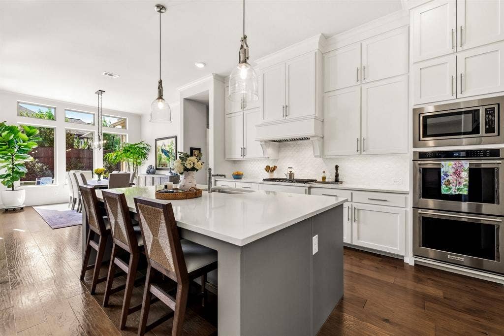 404 Travelers Terrace, Argyle, TX 76226 Notice the double ovens & pretty pendant lights.