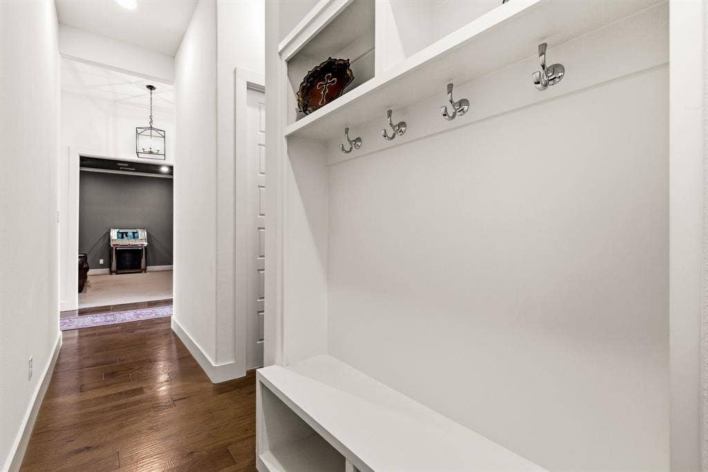 404 Travelers Terrace, Argyle, TX 76226 This hallway offers custom built-ins and the half bathroom.