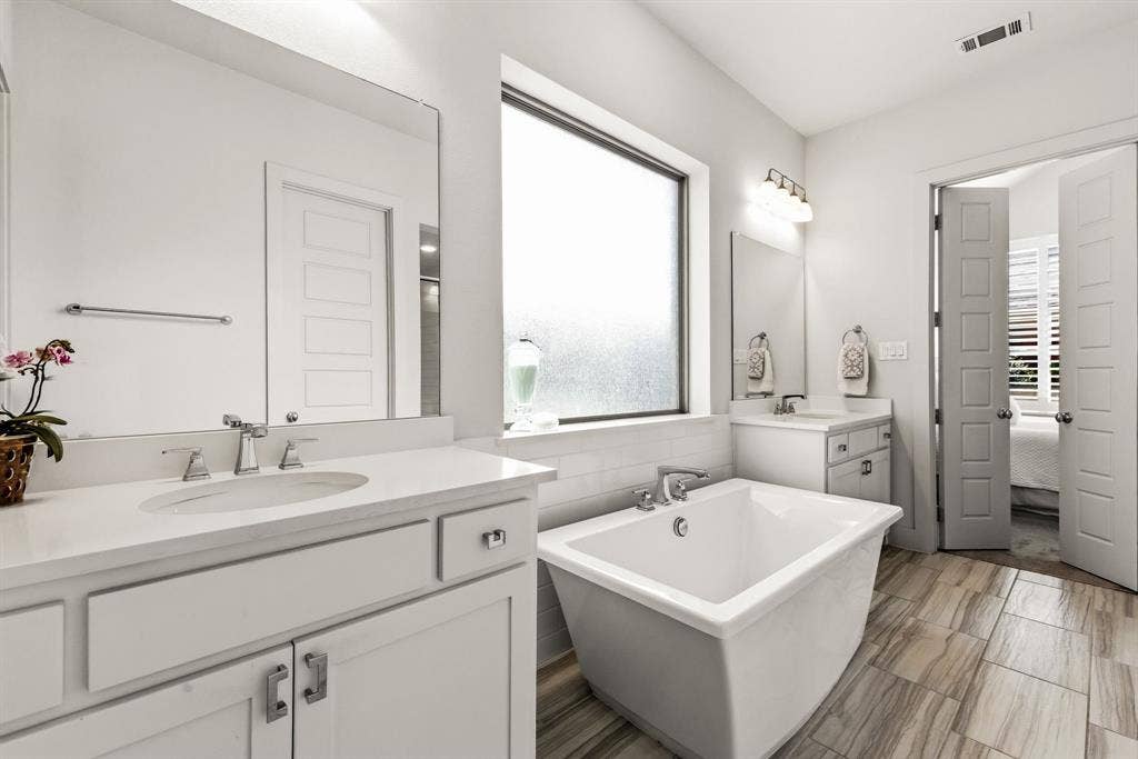 404 Travelers Terrace, Argyle, TX 76226 There is a free standing bathtub and double vanities in the primary bathroom.