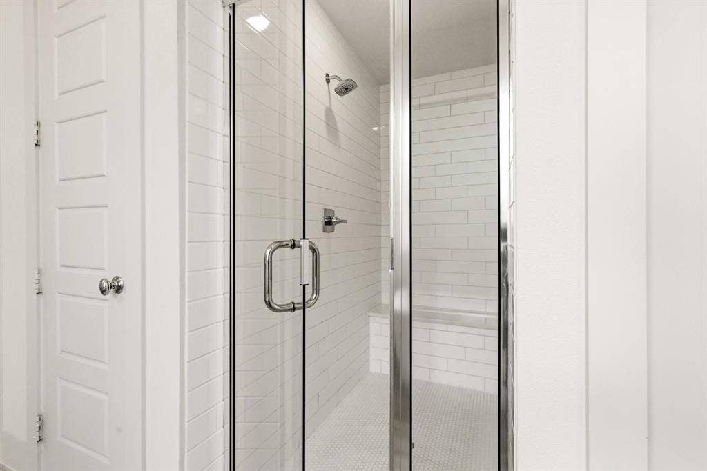 404 Travelers Terrace, Argyle, TX 76226 There is a large walk in shower with a seat in the primary bathroom.