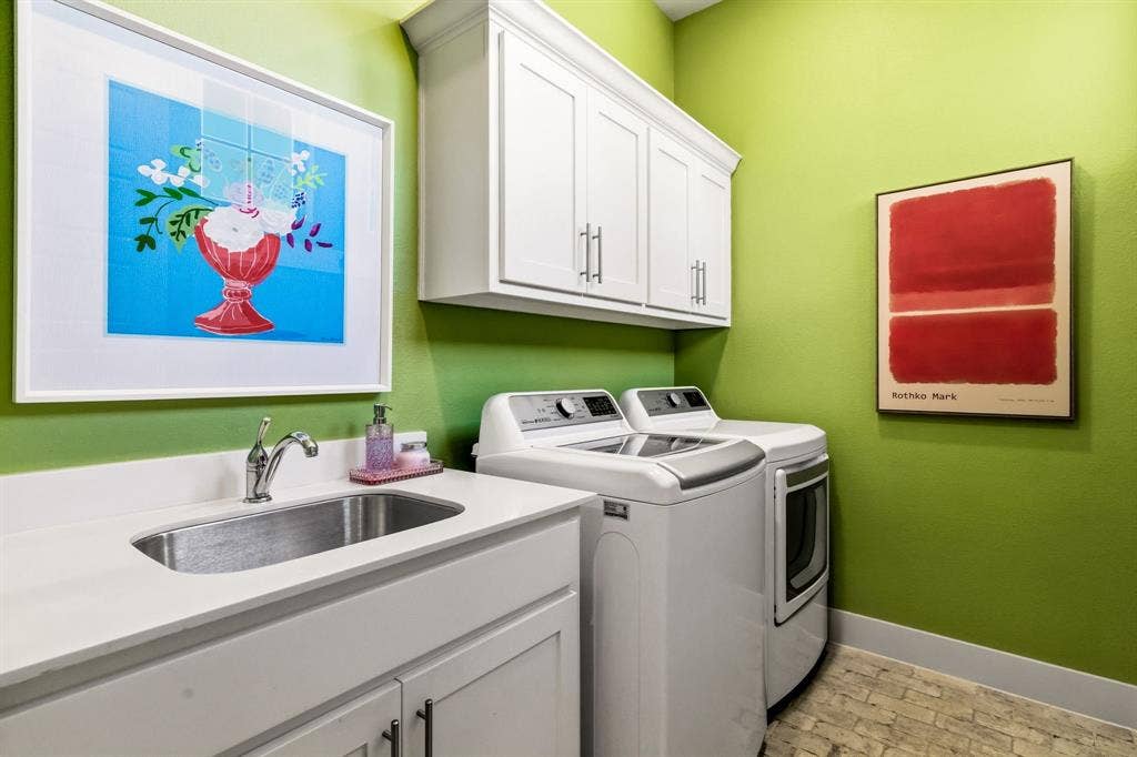 404 Travelers Terrace, Argyle, TX 76226 The utility room features a brick floor, a sink and built in cabinnets.